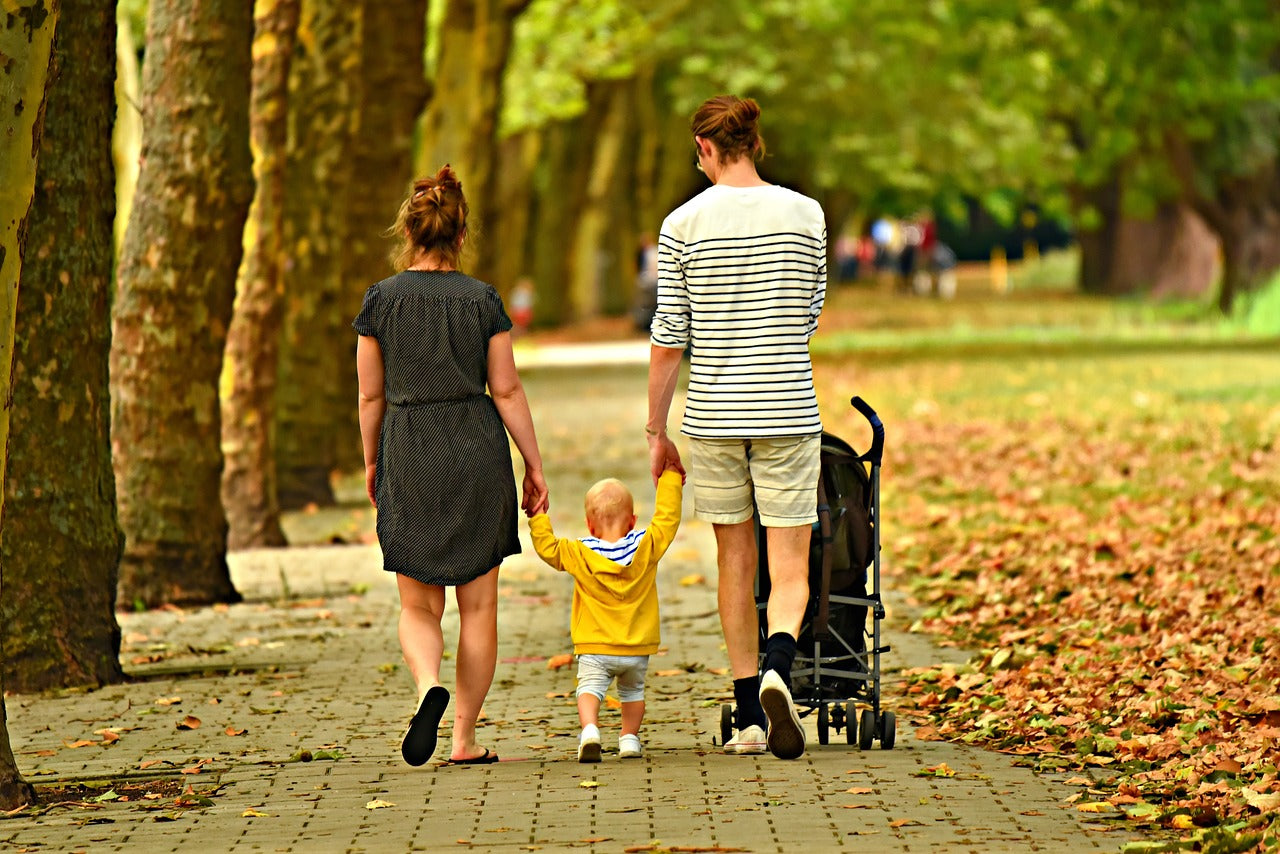 Mother and Father holding hands and walking