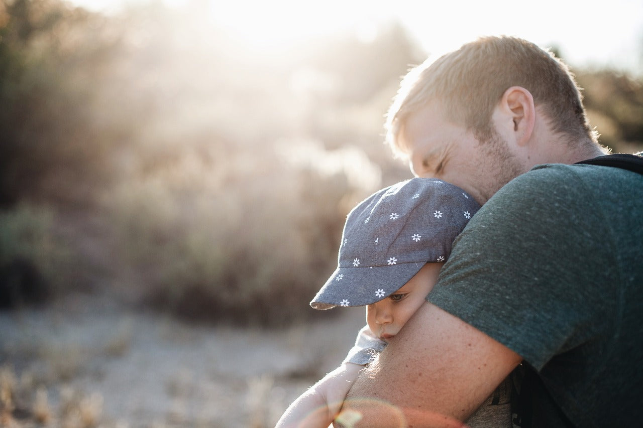 Father holding child tightly 