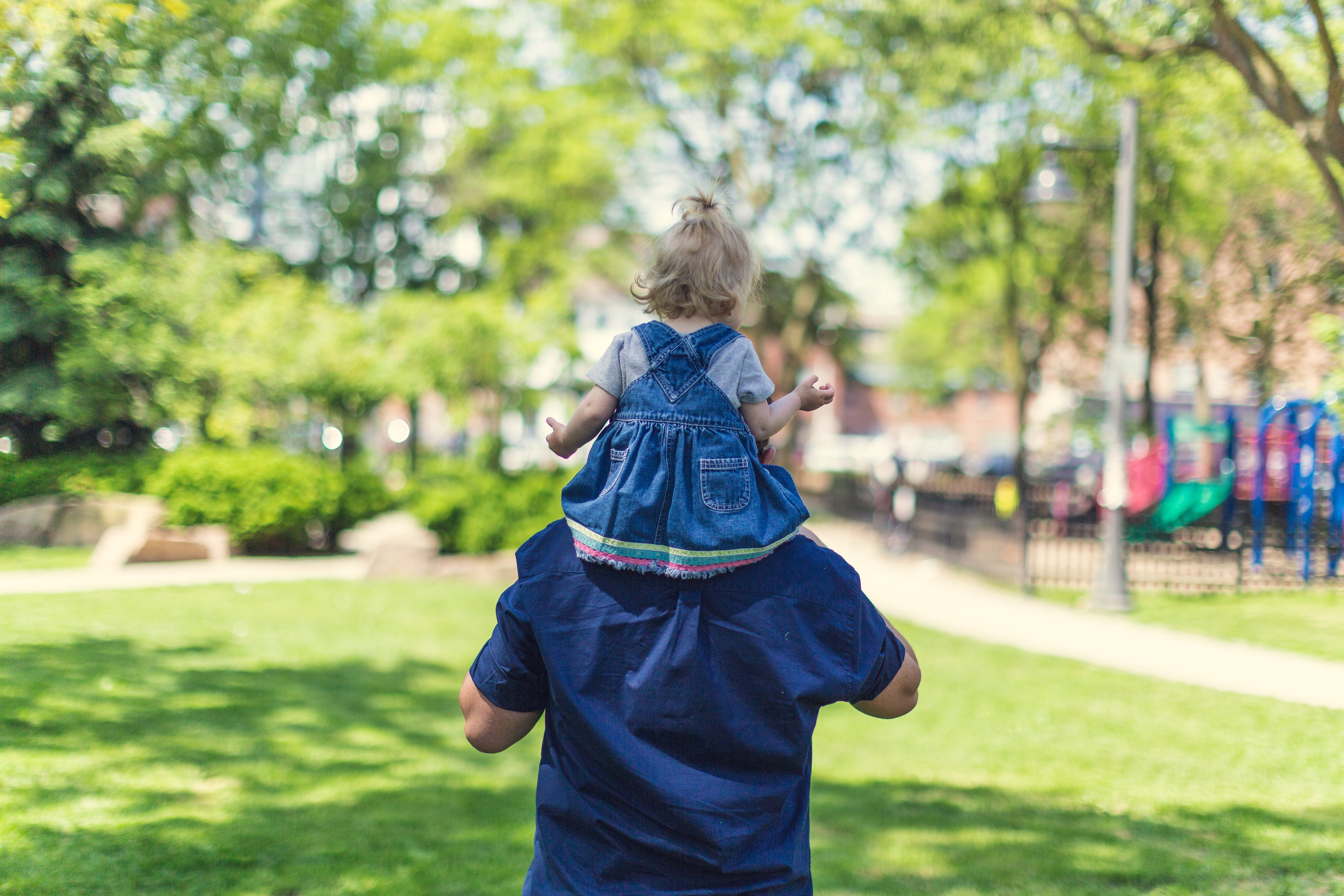 Small child on the shoulders of a man 